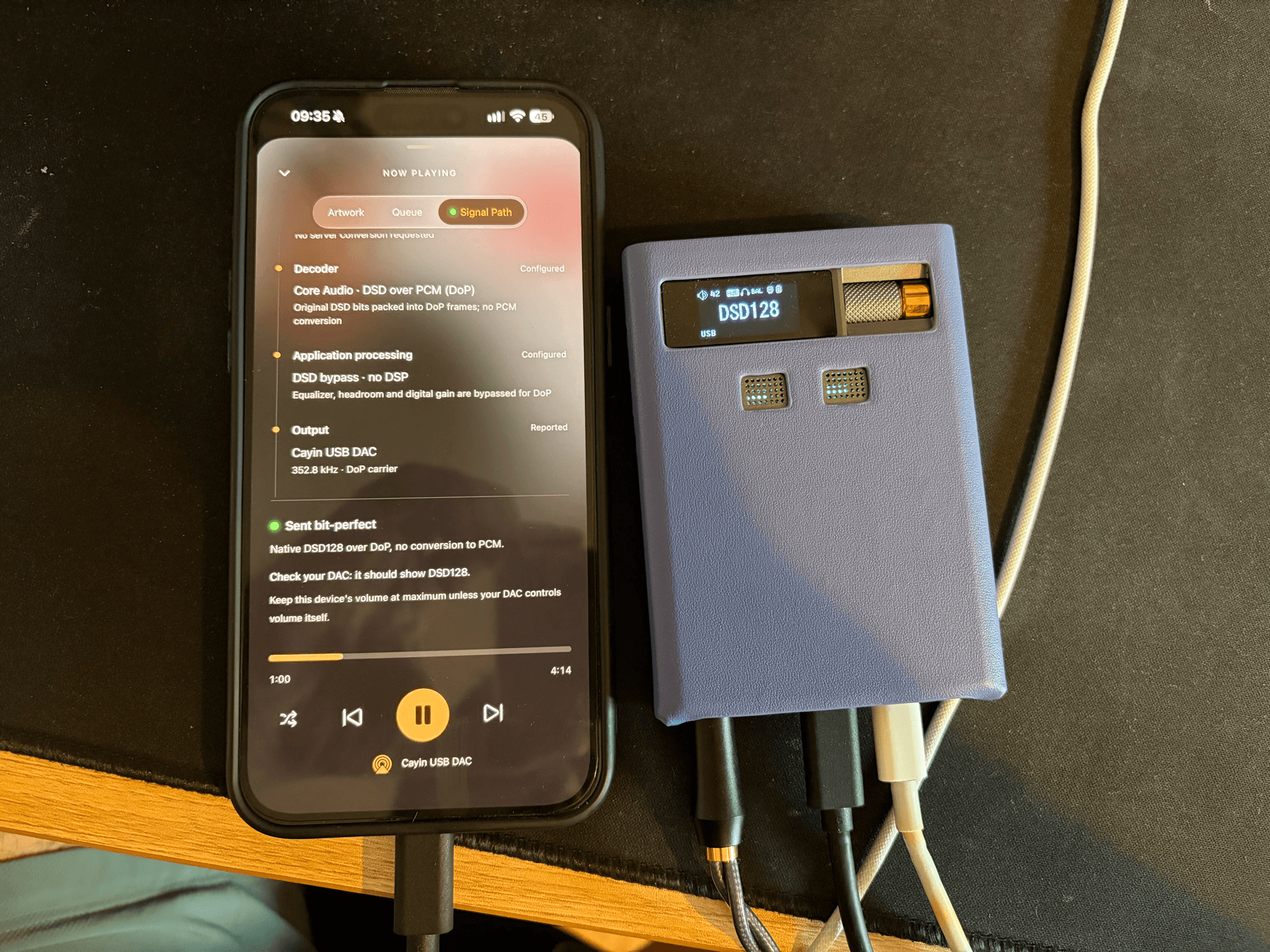 An iPhone playing DSD128 next to a Cayin RU9 showing DSD128